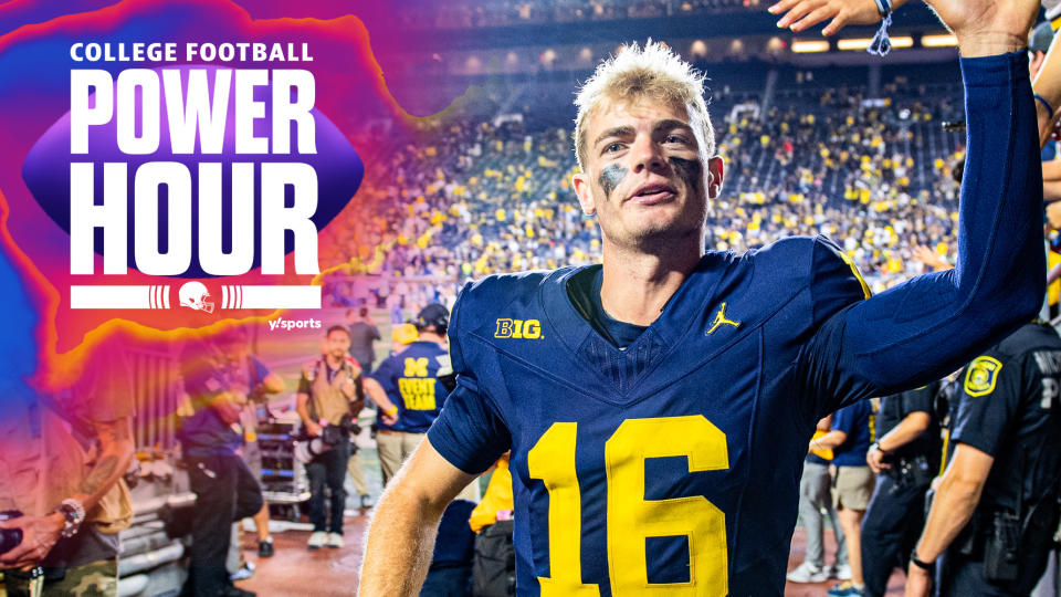 Michigan Wolverines QB Davis Warren high-fives fans after his team's Week 1 win over Fresno State. In Tuesday's AP Poll, the Wolverines are ranked 10th. (Photo by Aaron J. Thornton/Getty Images) 