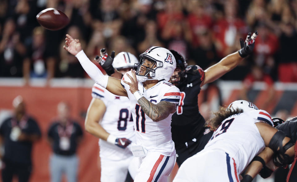 SALT LAKE CITY, UT - SEPTEMBER 28: Noah Fifita #11 of the Arizona Wildcats throws under pressure from the Utah Utes during the first half of their game at Rice Eccles Stadium on September 28, 2024 in Salt Lake City, Utah. (Photo by Chris Gardner/Getty Images)