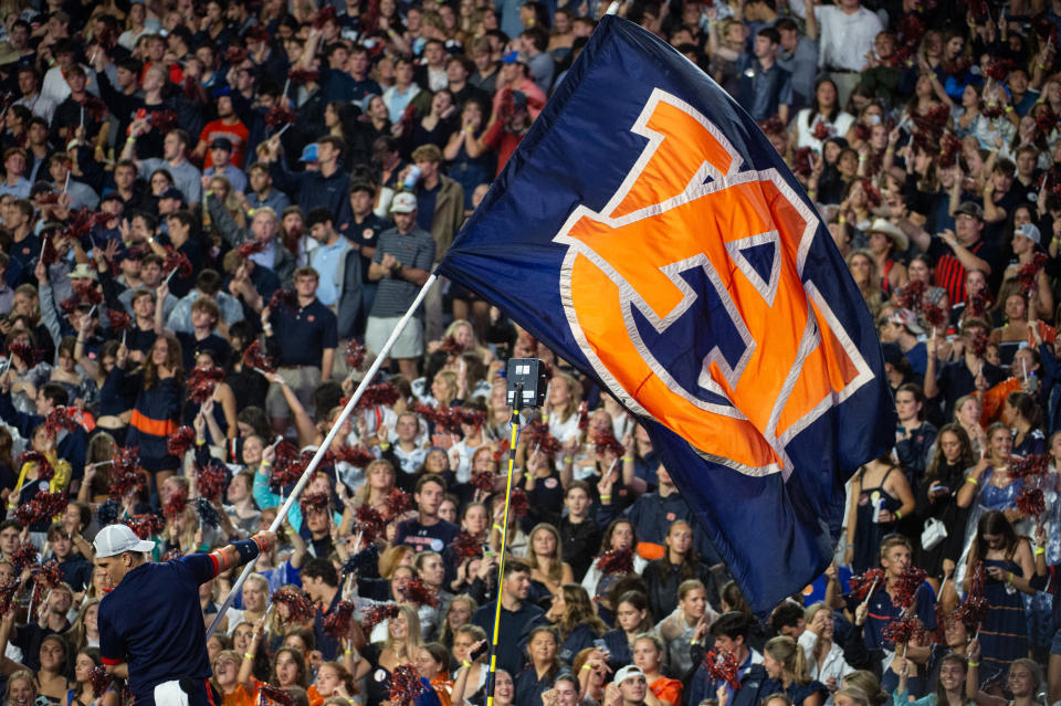 AUBURN, ALABAMA - SEPTEMBER 14: A cheerleader with the Auburn Tigers waves their flag during their game against the New Mexico Lobos at Jordan-Hare Stadium on September 14, 2024 in Auburn, Alabama. (Photo by Michael Chang/Getty Images) *** Local Caption ***