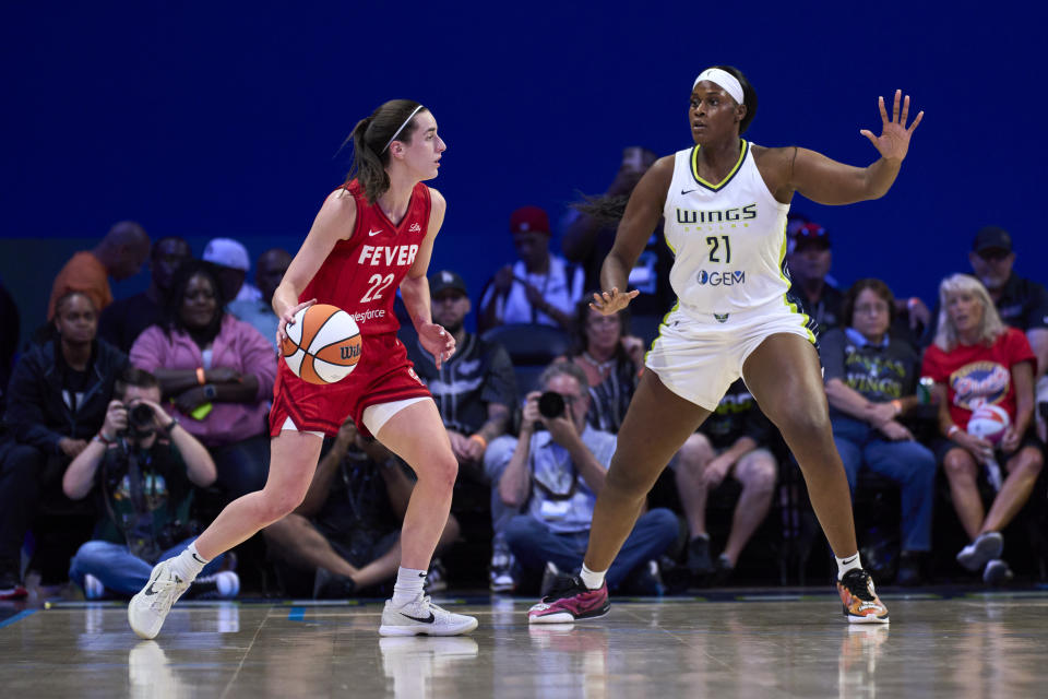 ARLINGTON, TEXAS - JULY 17: Caitlin Clark #22 of the Indiana Fever drives to the basket against Kalani Brown #21 of the Dallas Wings at the College Park Center on July 17, 2024 in Arlington, Texas. NOTE TO USER: User expressly acknowledges and agrees that, by downloading and or using this photograph, User is consenting to the terms and conditions of the Getty Images License Agreement. (Photo by Cooper Neill/Getty Images)