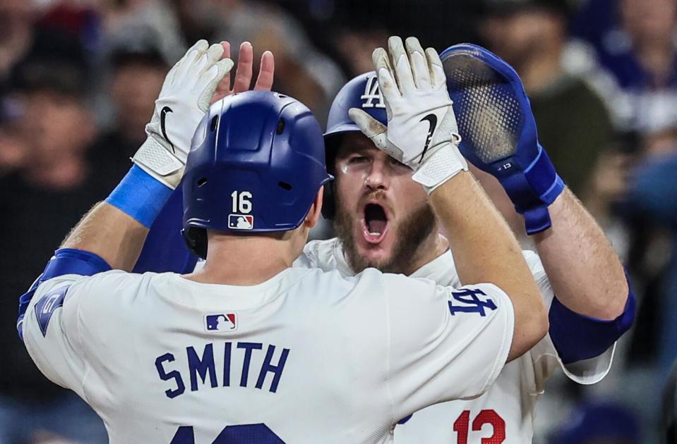 Dodgers third baseman Max Muncy, right, celebrates with catcher Will Smith after Smith hit a two-run home run.