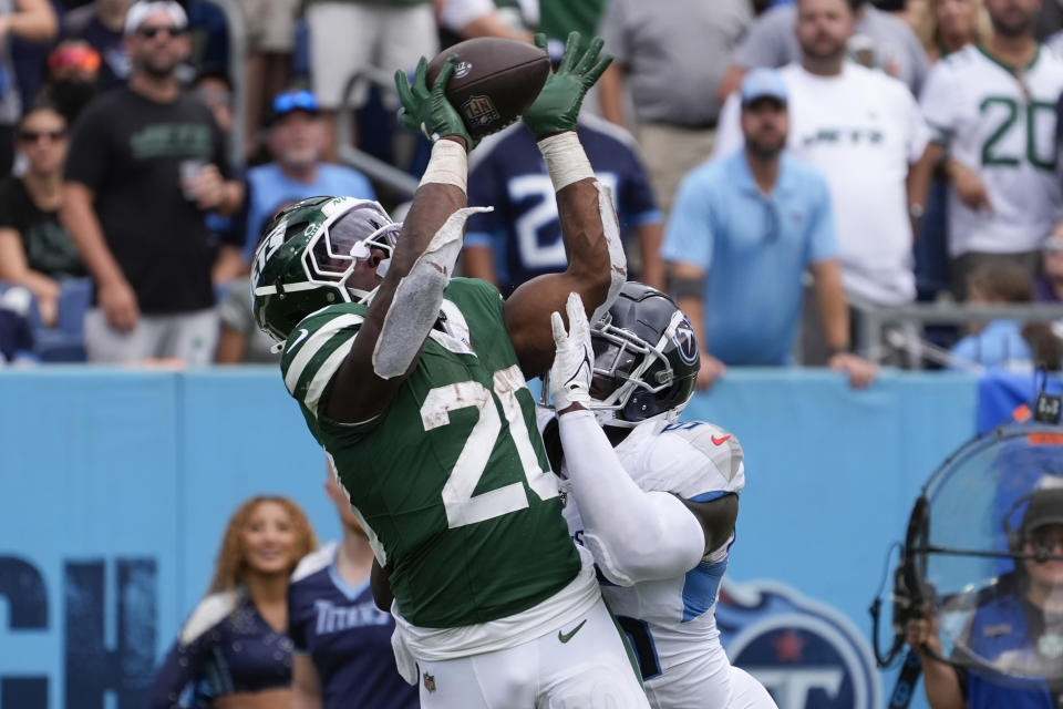 New York Jets running back Breece Hall (20) catches a touchdown pass against Tennessee Titans linebacker Kenneth Murray Jr. (56) in the second half of an NFL football game in Nashville, Tenn., on Sunday, Sept. 15, 2024. (AP Photo/George Walker IV)