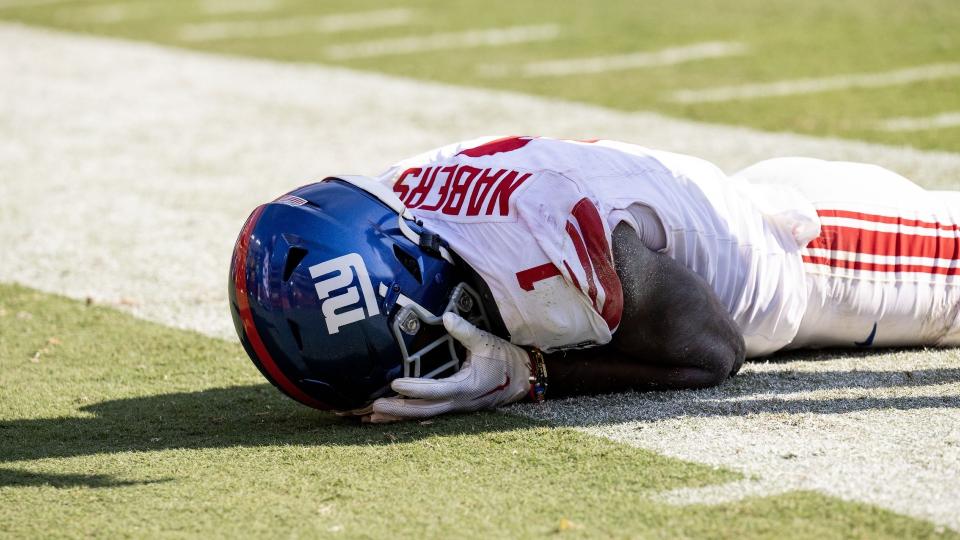 New York Giants wide receiver Malik Nabers (1) holds his face after dropping a pass against the Washington Commanders in the second half at Commanders Field.