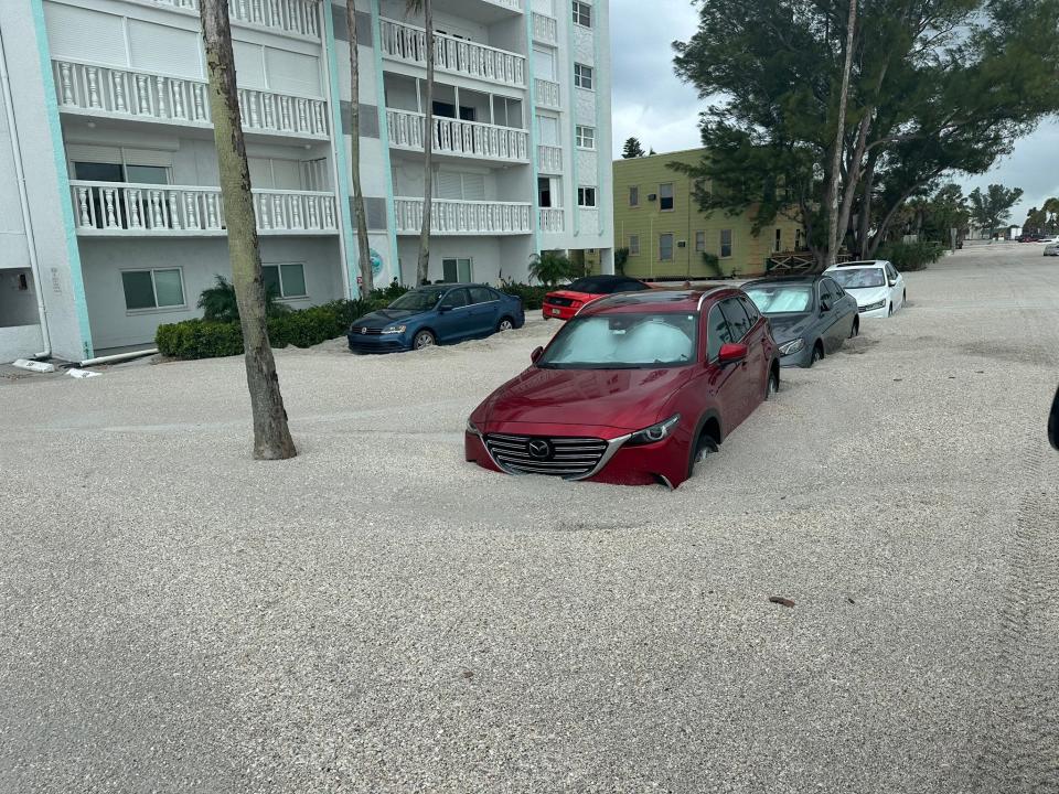 Parked cars are surrounded by sand picked up by Hurricane Helene in Pinellas County, Florida (Pinellas County Sheriff’s Office/X)