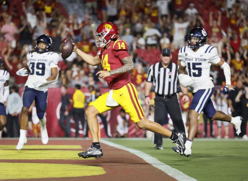 USC quarterback Jayden Maiava runs into the end zone during the Trojans' win over Utah State at the Coliseum on Saturday