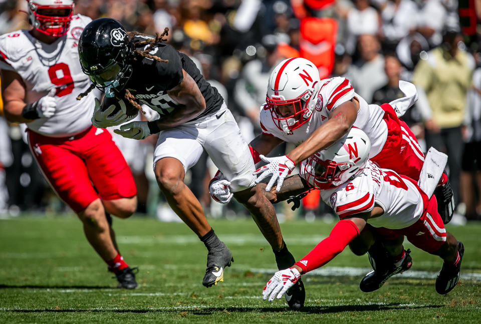 BOULDER, CO - SEPTEMBER 09: Colorado wide receiver Xavier Weaver (10) attempts to split the tackle of Nebraska Defensive back Quinton Newsome (6) and Defensive back DeShon Singleton (8) during the home opener game between the Colorado Buffaloes and the the Nebraska Cornhuskers on Saturday, September 9, 2023 at Folsom Field in Boulder, CO. (Photo by Nick Tre. Smith/Icon Sportswire via Getty Images)