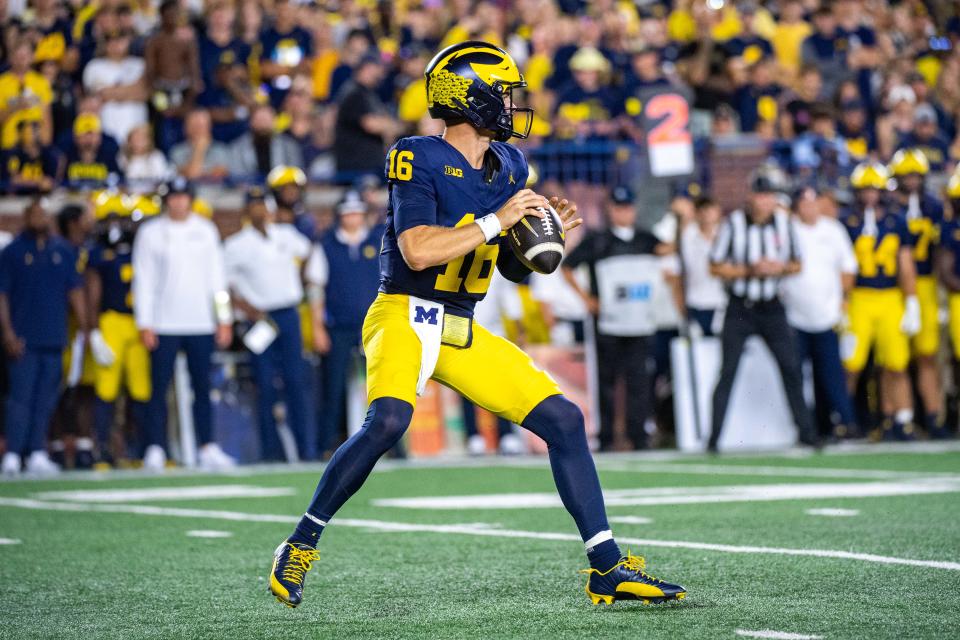 ANN ARBOR, MICHIGAN - AUGUST 31: Davis Warren #16 of the Michigan Wolverines looks to throw the ball downfield during the second half of a college football game against the Fresno St. Bulldogs at Michigan Stadium on August 31, 2024 in Ann Arbor, Michigan. The Michigan Wolverines won the game 30-10. (Photo by Aaron J. Thornton/Getty Images)