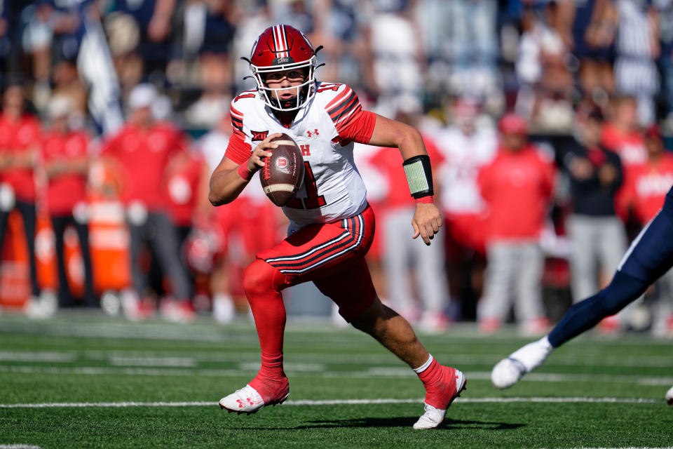 Sep 14, 2024; Logan, Utah, USA; Utah Utes quarterback Isaac Wilson (11) runs with the ball against the Utah State Aggies at Merlin Olsen Field at Maverik Stadium. Mandatory Credit: Jamie Sabau-Imagn Images