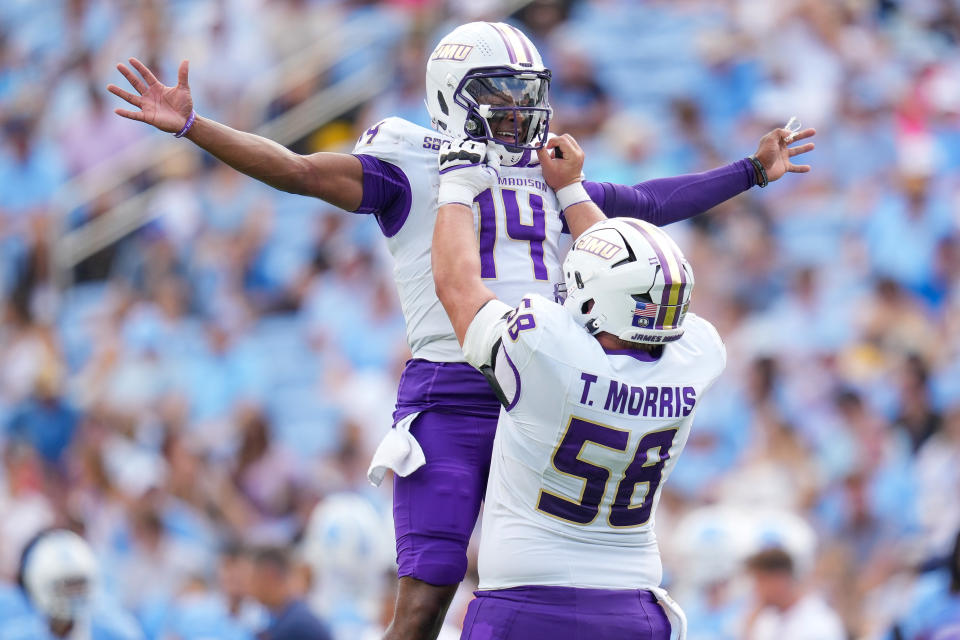 CHAPEL HILL, NORTH CAROLINA - SEPTEMBER 21: Alonza Barnett III #14 celebrates with Tanner Morris #58 of the James Madison Dukes after throwing for a touchdown against the North Carolina Tar Heels during the first half of the game at Kenan Memorial Stadium on September 21, 2024 in Chapel Hill, North Carolina. (Photo by Grant Halverson/Getty Images)