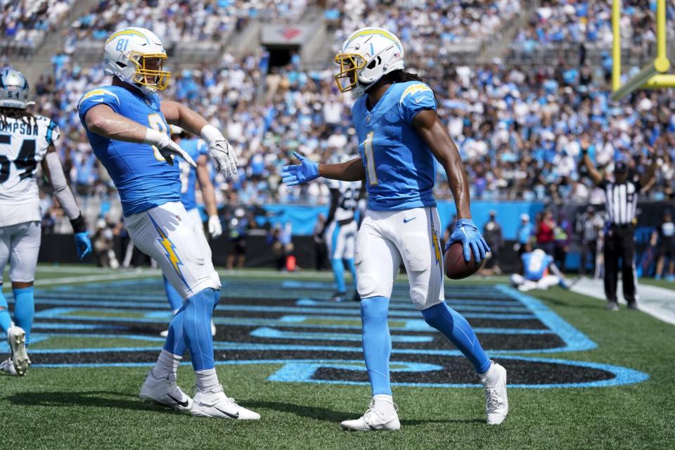 The Chargers' Quentin Johnston and Will Dissly celebrate a touchdown catch.