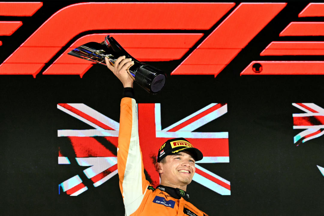 McLaren's British driver Lando Norris celebrates winning on the podium after the Formula One Singapore Grand Prix night race at the Marina Bay Street Circuit in Singapore on 22 September 2024.