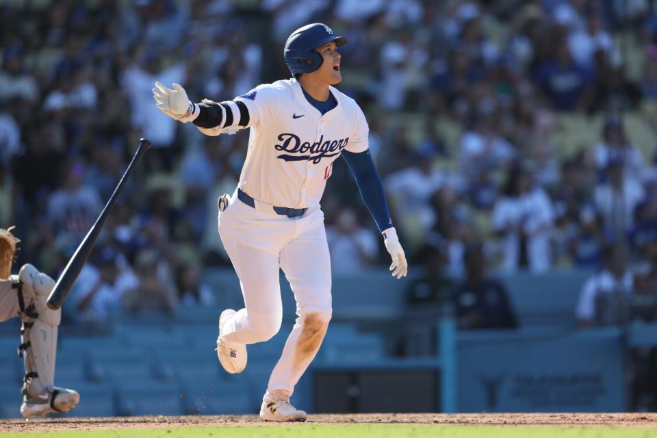 Shohei Ohtani hits his 53rd home run of the season in the eighth inning against the Colorado Rockies on Sunday.