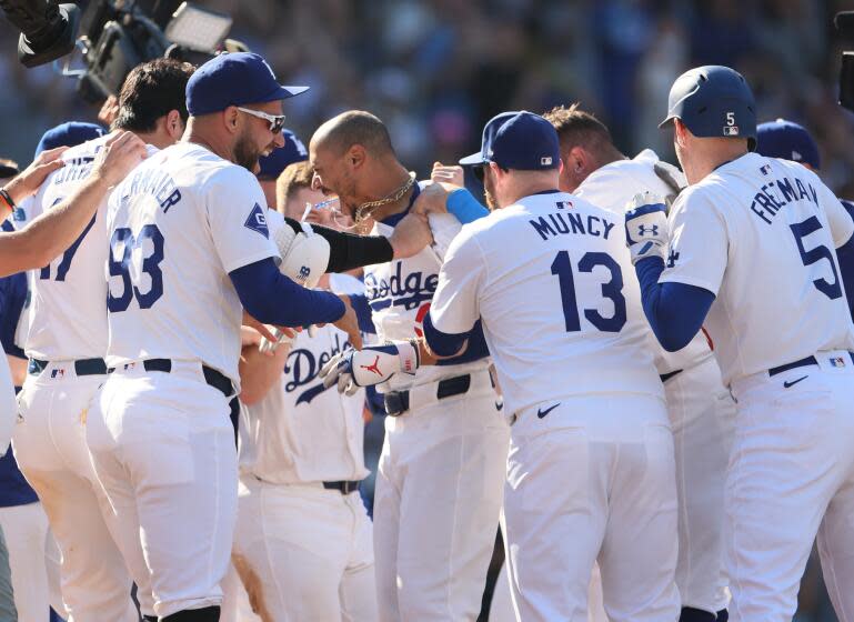 Los Angeles, CA - September 22: Los Angeles Dodgers' Mookie Betts celebrates with teammates.