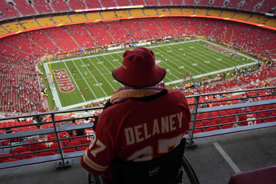 A fan watches warmups at Arrowhead Stadium ahead of the game-delaying storm. (AP Photo/Charlie Riedel)