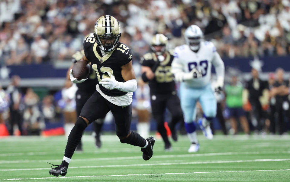 Sep 15, 2024; Arlington, Texas, USA; New Orleans Saints wide receiver Chris Olave (12) runs with the ball during the first half against the Dallas Cowboys at AT&T Stadium. Mandatory Credit: Kevin Jairaj-Imagn Images