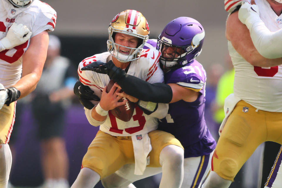 MINNEAPOLIS, MINNESOTA - SEPTEMBER 15: Blake Cashman #51 of the Minnesota Vikings sacks quarterback Brock Purdy #13 of the San Francisco 49ers during the third quarter at U.S. Bank Stadium on September 15, 2024 in Minneapolis, Minnesota. (Photo by Adam Bettcher/Getty Images)