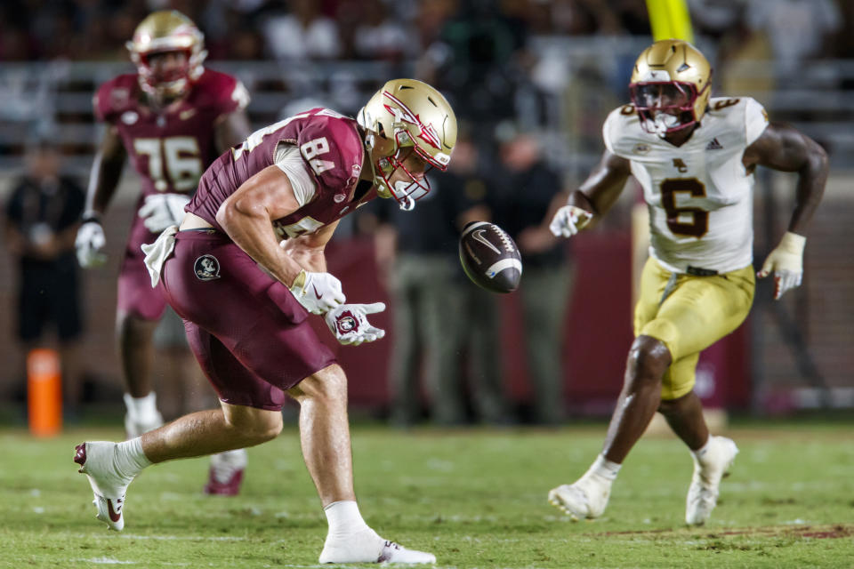 Florida State tight end Kyle Morlock (84) cannot hang on to a pass as Boston College defensive end Donovan Ezeiruaku (6) closes during the second half of an NCAA college football game, Monday, Sept. 2, 2024, in Tallahassee, Fla. (AP Photo/Colin Hackley)