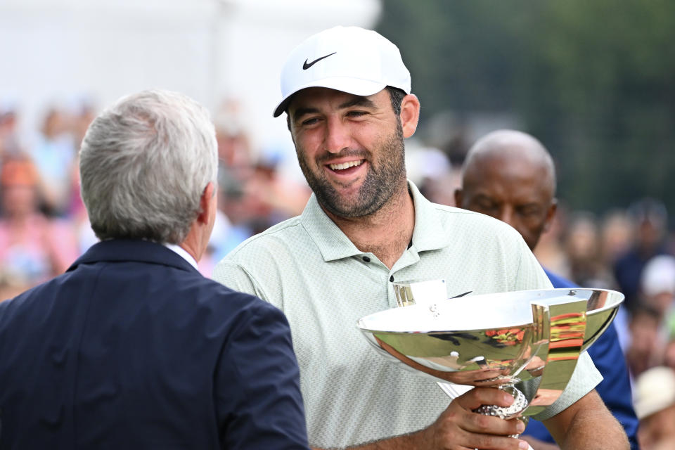 ATLANTA, GEORGIA - SEPTEMBER 01: PGA TOUR Commissioner Jay Monahan awards Scottie Scheffler of the United States the FedEx Cup after winning the TOUR Championship at East Lake Golf Club on September 01, 2024 in Atlanta, Georgia. (Photo by Tracy Wilcox/PGA TOUR via Getty Images)