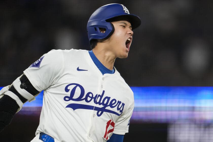 Dodgers designated hitter Shohei Ohtani reacts as he singles against the Padres Wednesday at Dodger Stadium.