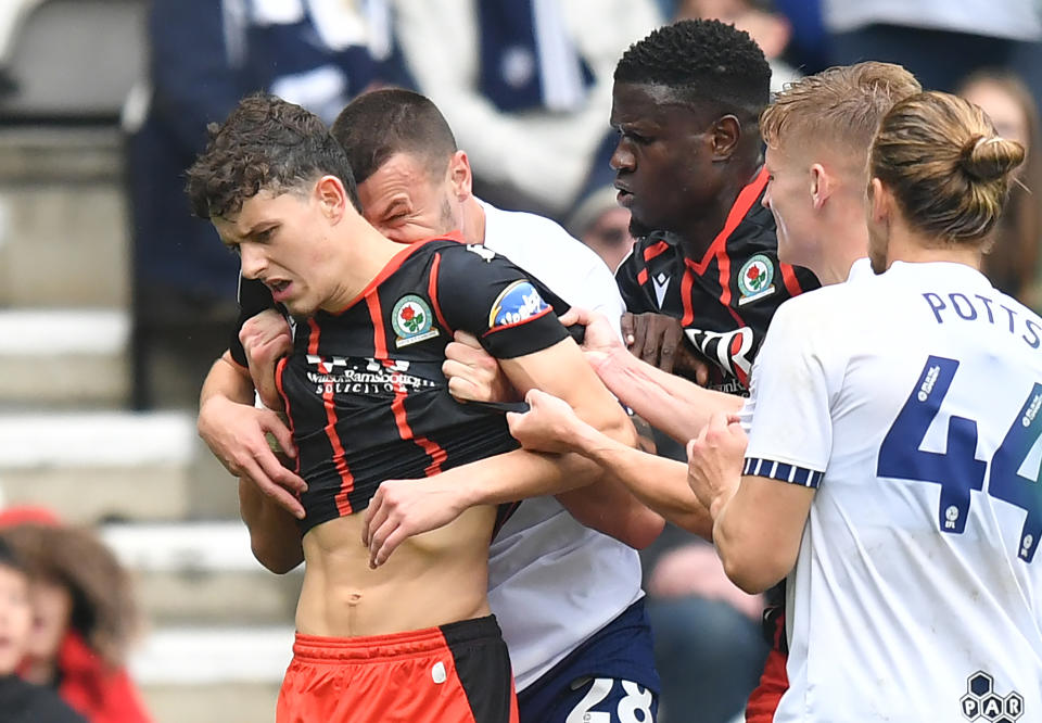 Blackburn Rovers' Owen Beck seems to be bitten on the neck by Preston North End's Milutin Osmajic during a match. (Dave Howarth - CameraSport via Getty Images)