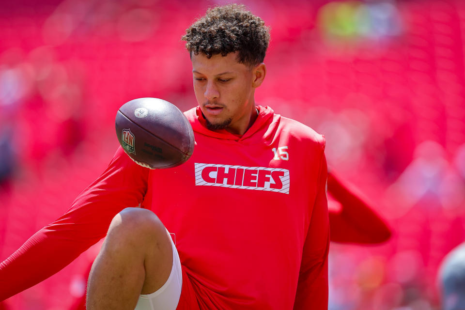 KANSAS CITY, MISSOURI - AUGUST 17: Patrick Mahomes #15 of the Kansas City Chiefs kicks a football like a soccer ball during pregame warmups prior to a preseason game against the Detroit Lions at GEHA Field at Arrowhead Stadium on August 17, 2024 in Kansas City, Missouri. (Photo by David Eulitt/Getty Images)