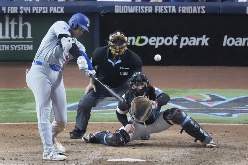 Dodgers' Shohei Ohtani hits a home run during the seventh inning of a baseball game against the Miami Marlins