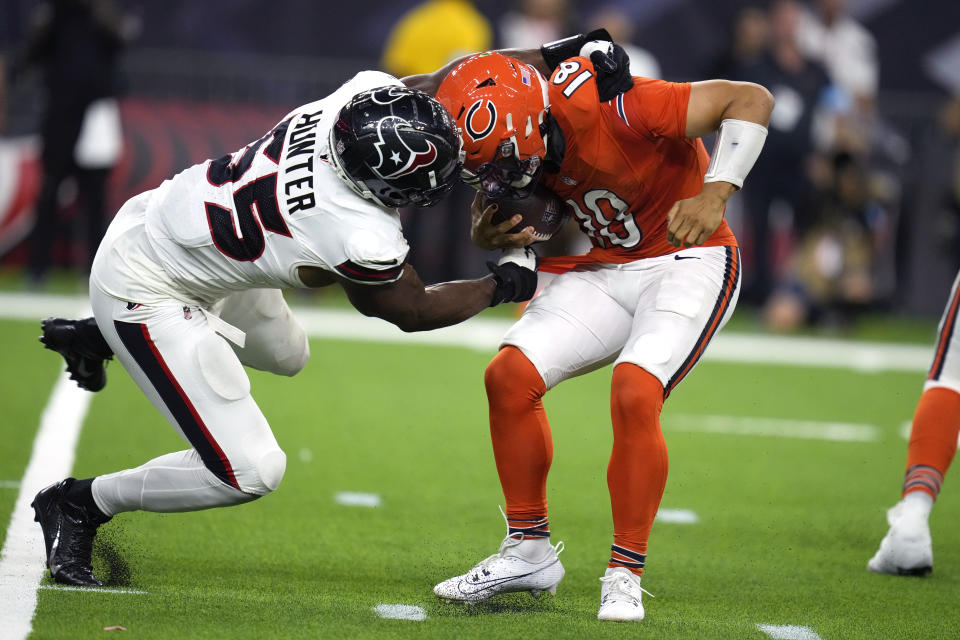 Chicago Bears quarterback Caleb Williams is grabbed by Houston Texans defensive end Danielle Hunter. (AP Photo/Eric Christian Smith)