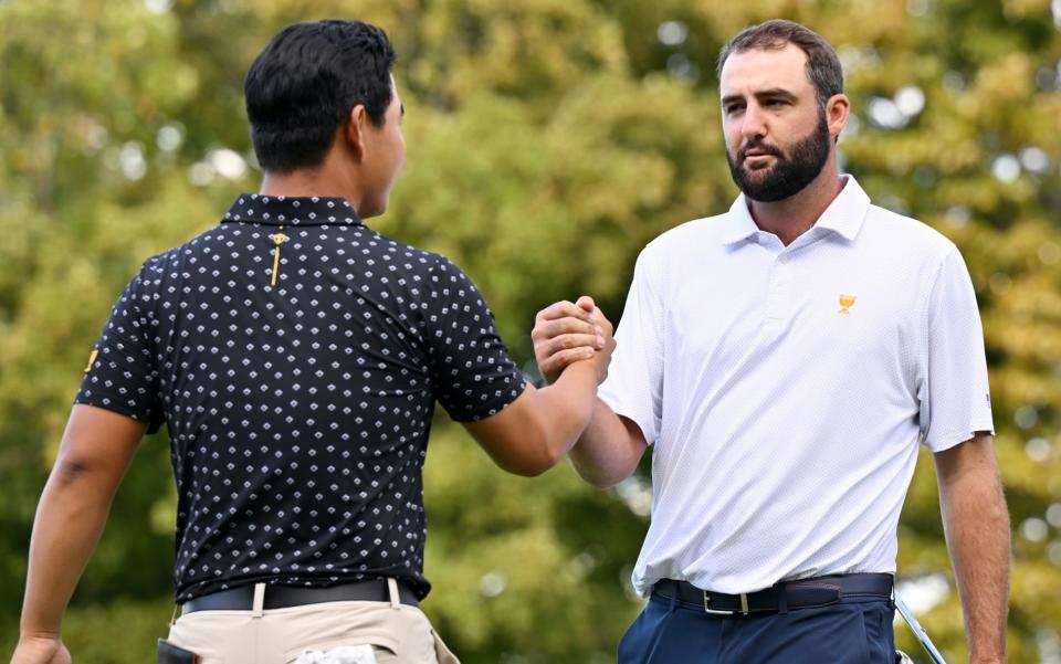 Tom Kim of South Korea and the International Team and Scottie Scheffler of the USA Team shake hands after Scheffler and Russell Henley defeated Kim and Sungjae Im 3&2 during Thursday's fourball matches on day one of the 2024 Presidents Cup at The Royal Montreal Golf Club on September 26, 2024 in Montreal