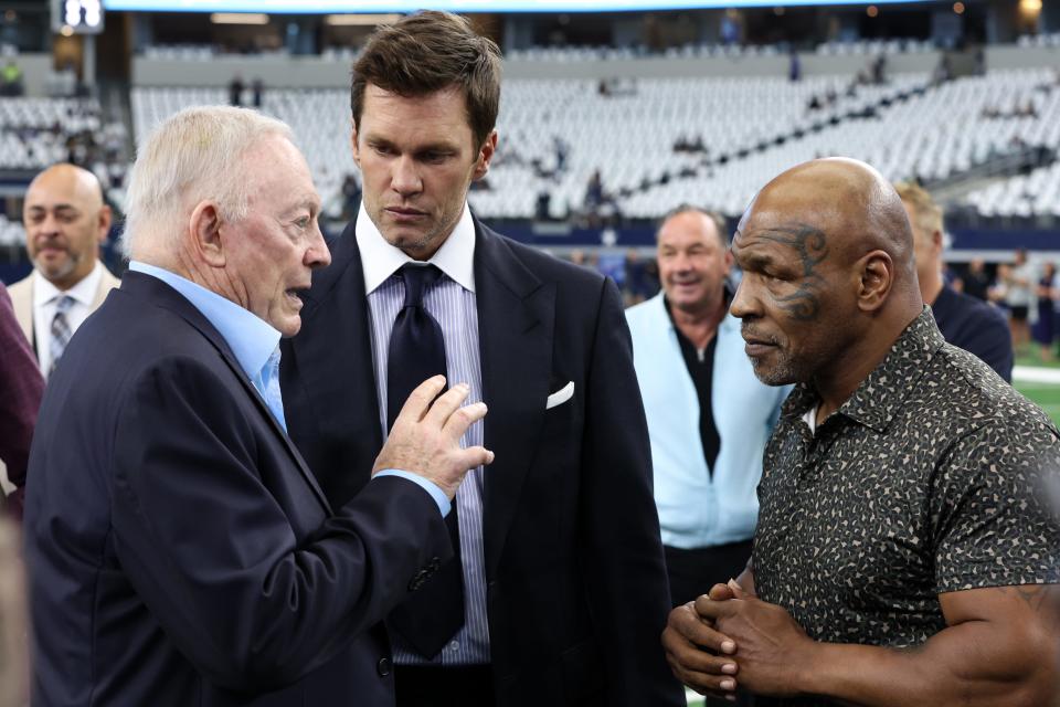 Sep 15, 2024; Arlington, Texas, USA; (L ro R) Dallas Cowboys owner Jerry Jones, Fox Sports commentator Tom Brady and boxer Mike Tyson pose for a photo on the field before a game between the New Orleans Saints and Cowboys at AT&T Stadium. Mandatory Credit: Tim Heitman-Imagn Images