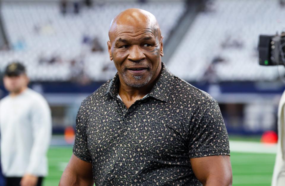 Sep 15, 2024; Arlington, Texas, USA; Boxer Mike Tyson on the field before the game between the Dallas Cowboys and New Orleans Saints at AT&T Stadium. Mandatory Credit: Kevin Jairaj-Imagn Images