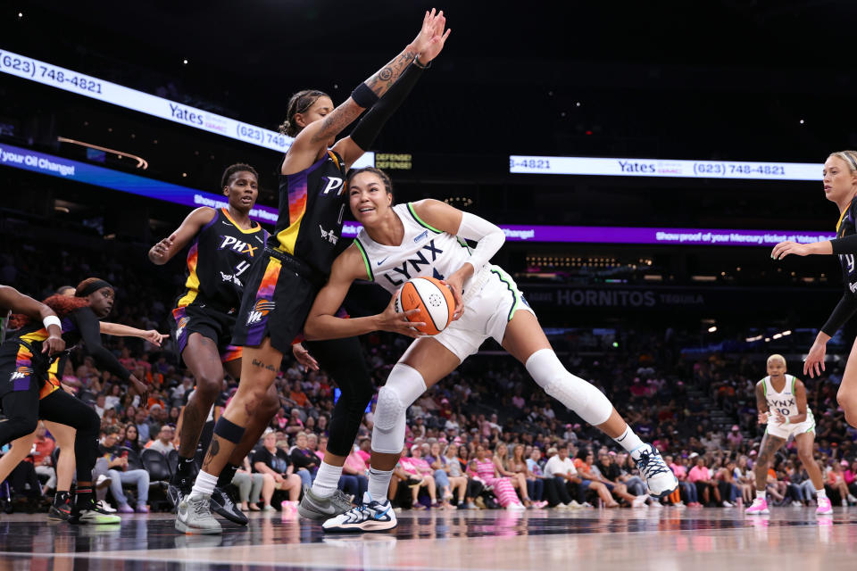 PHOENIX, ARIZONA - AUGUST 28: Kayla McBride #21 of the Minnesota Lynx drives into Natasha Cloud #0 of the Phoenix Mercury during the first half at Footprint Center on August 28, 2024 in Phoenix, Arizona.The Lynx defeated the Mercury 89-76. NOTE TO USER: User expressly acknowledges and agrees that, by downloading and or using this photograph, User is consenting to the terms and conditions of the Getty Images License Agreement. (Photo by Chris Coduto/Getty Images)