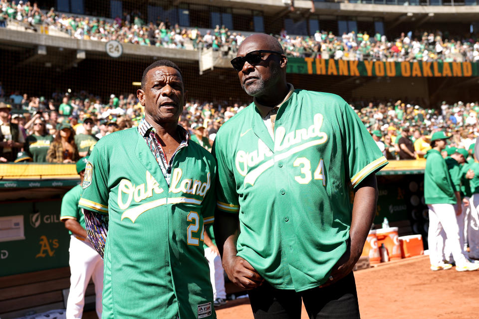 Oakland A's legends Rickey Henderson (L) and Dave Stewart on the field before the game. (Ezra Shaw/Getty Images)