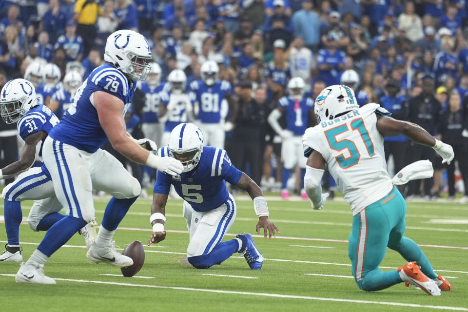 Indianapolis Colts quarterback Anthony Richardson (5) fumbles the ball during the first half of an NFL football game against the Miami Dolphins, Sunday, Oct. 20, 2024 in Indianapolis. (AP Photo/Michael Conroy)