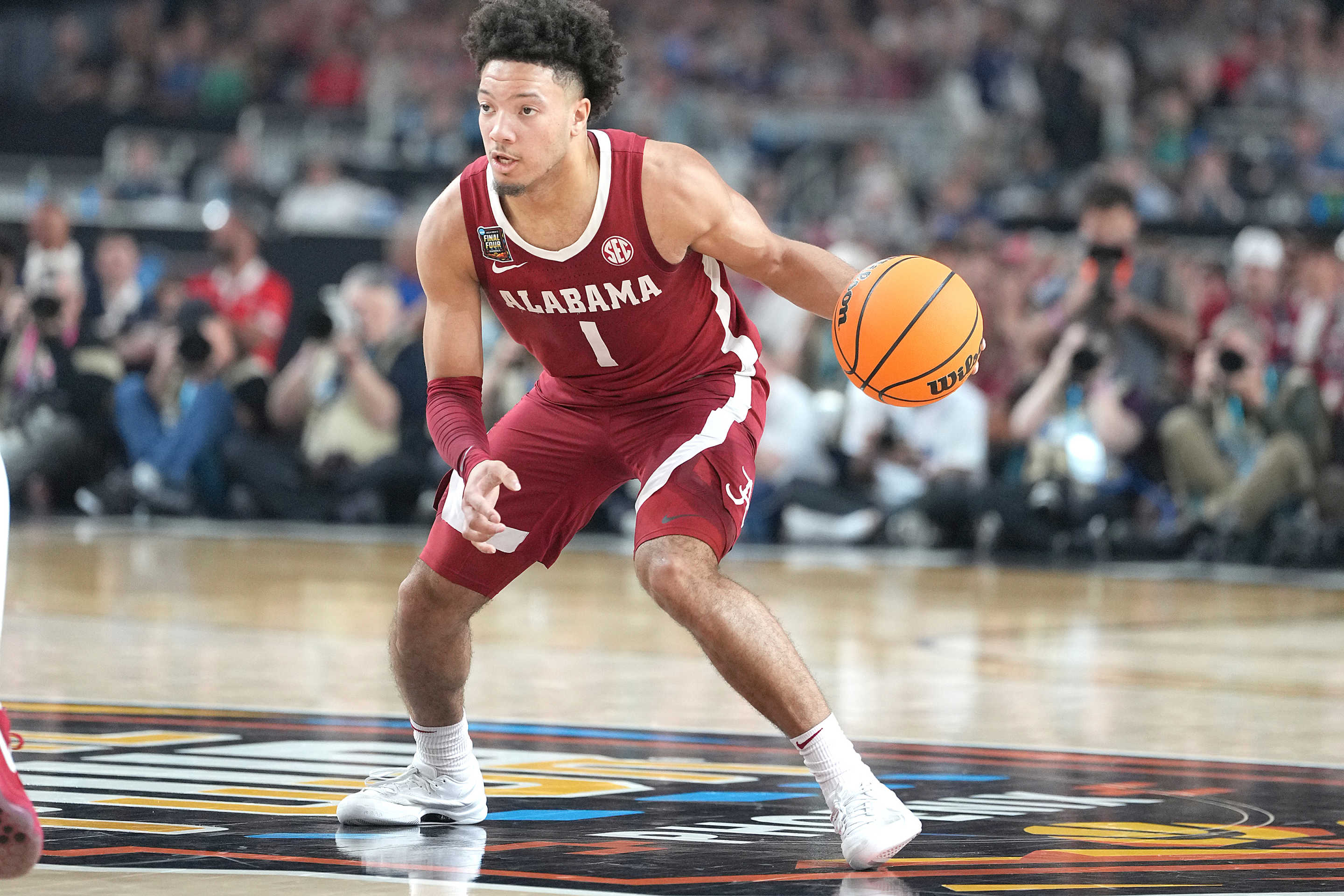 GLENDALE, ARIZONA - APRIL 06: Mark Sears #1 of the Alabama Crimson Tide dribbles the ball during the NCAA Mens Basketball Tournament Final Four semifinal game agains The Connecticut Huskies at State Farm Stadium on April 06, 2024 in Glendale, Arizona. (Photo by Mitchell Layton/Getty Images)