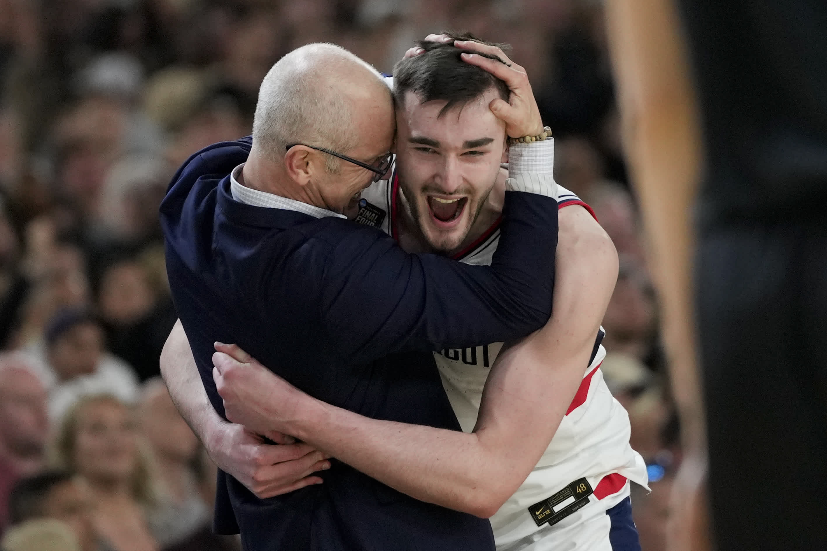 FILE -UConn head coach Dan Hurley celebrates with forward Alex Karaban (11) after their win against Purdue in the NCAA college Final Four championship basketball game, Monday, April 8, 2024, in Glendale, Ariz. (AP Photo/David J. Phillip, File)