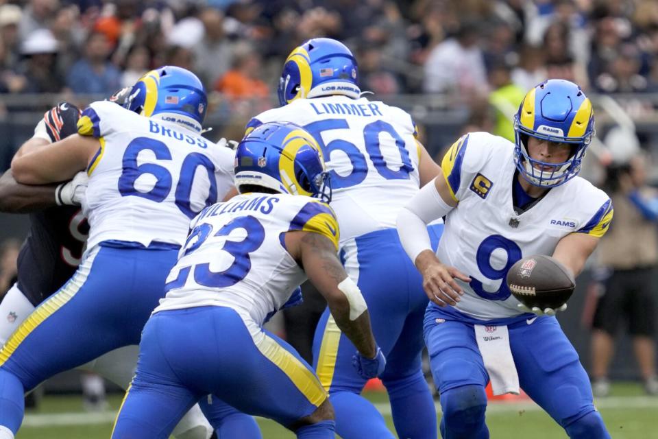 Rams quarterback Matthew Stafford hands the ball to running back Kyren Williams