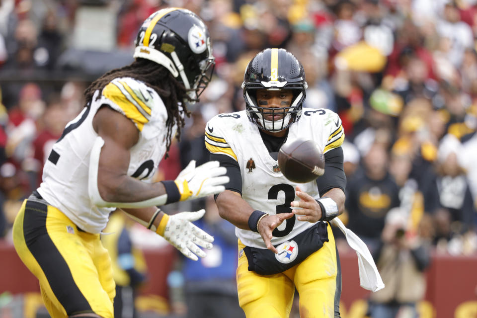 Nov 10, 2024; Landover, Maryland, USA; Pittsburgh Steelers quarterback Russell Wilson (3) tosses the ball to Steelers running back Najee Harris (22) during the second half against the Washington Commanders at Northwest Stadium. Mandatory Credit: Amber Searls-Imagn Images