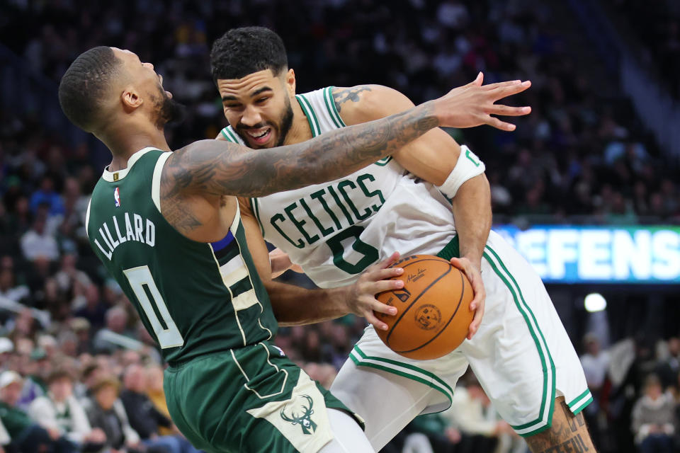 MILWAUKEE, WISCONSIN - NOVEMBER 10: Jayson Tatum #0 of the Boston Celtics is defended by Damian Lillard #0 of the Milwaukee Bucks during the second half of a game at Fiserv Forum on November 10, 2024 in Milwaukee, Wisconsin. NOTE TO USER: User expressly acknowledges and agrees that, by downloading and or using this photograph, User is consenting to the terms and conditions of the Getty Images License Agreement. (Photo by Stacy Revere/Getty Images)