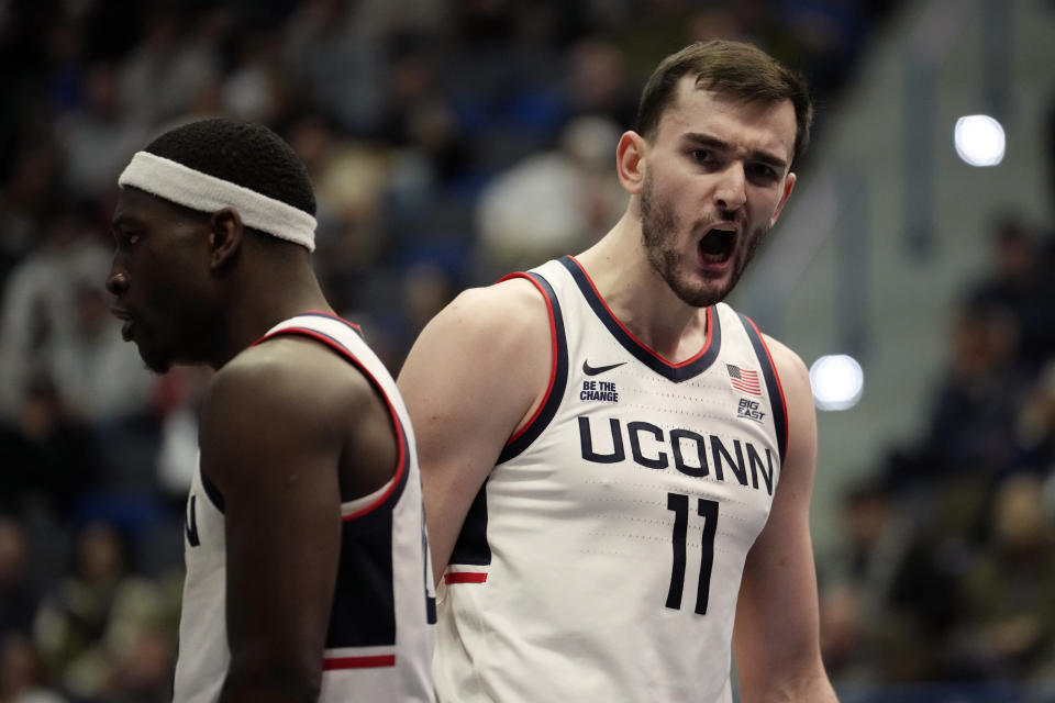 HARTFORD, CONNECTICUT - NOVEMBER 9: Alex Karaban #11 and Hassan Diarra #10 of the Connecticut Huskies react during the second half of an NCAA basketball game against the New Hampshire Wildcats at the XL Center on November 9, 2024 in Hartford, Connecticut. (Photo by Joe Buglewicz/Getty Images)