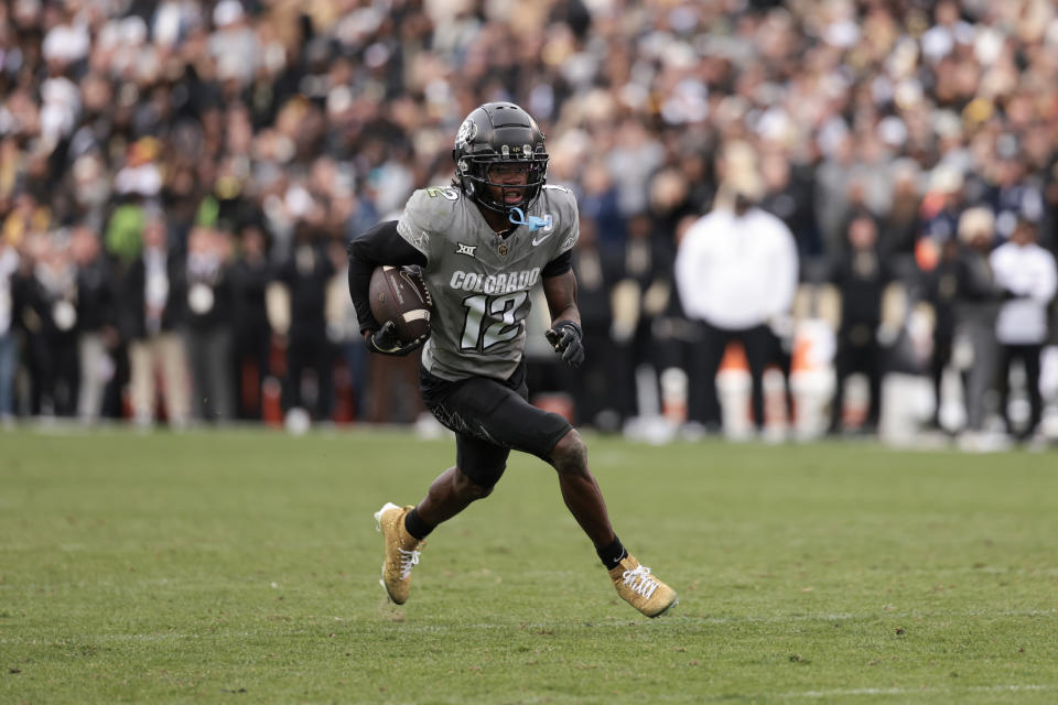 BOULDER, COLORADO - NOVEMBER 16: Travis Hunter #12 of Colorado Buffaloes runs with the ball during the fourth quarter against the Utah Utes at Folsom Field on November 16, 2024 in Boulder, Colorado. (Photo by Andrew Wevers/Getty Images)