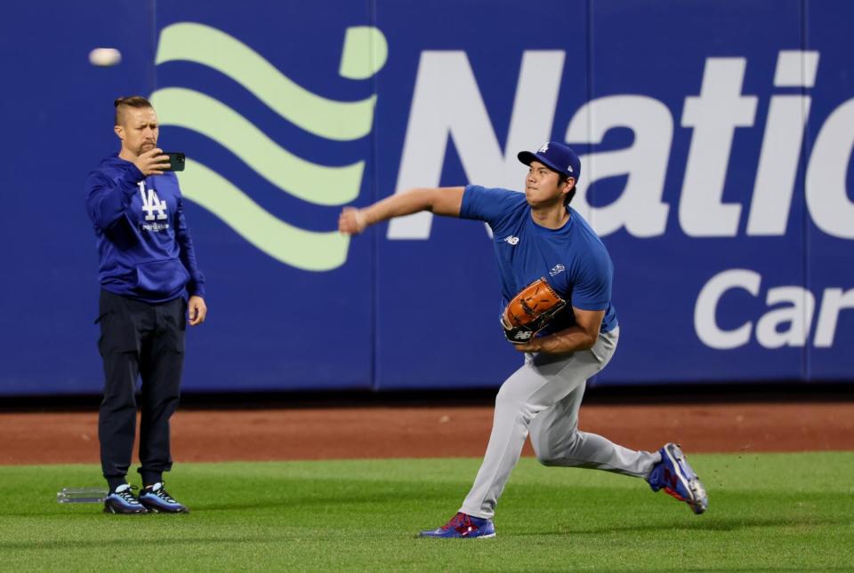 Shohei Ohtani throws in the outfield before Game 3 of the NLCS against the Mets at Citi Field.