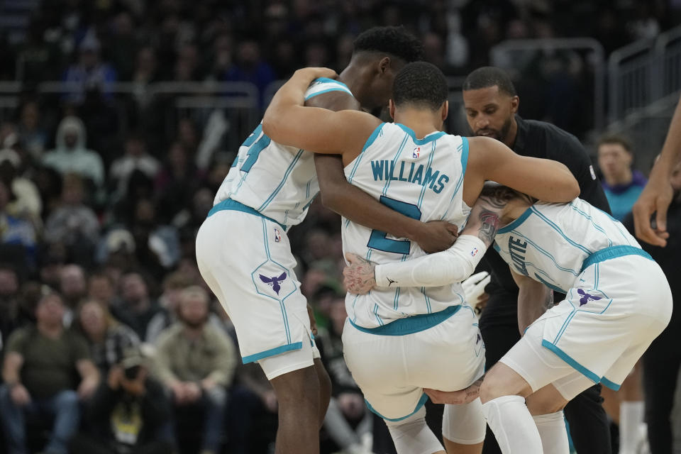 MILWAUKEE, WISCONSIN - NOVEMBER 23: Grant Williams #2 of the Charlotte Hornets helped by his teammates after being injured during the fourth quarter of a game against the Milwaukee Bucks at Fiserv Forum on November 23, 2024 in Milwaukee, Wisconsin. NOTE TO USER: User expressly acknowledges and agrees that, by downloading and or using this photograph, User is consenting to the terms and conditions of the Getty Images License Agreement. (Photo by Patrick McDermott/Getty Images)