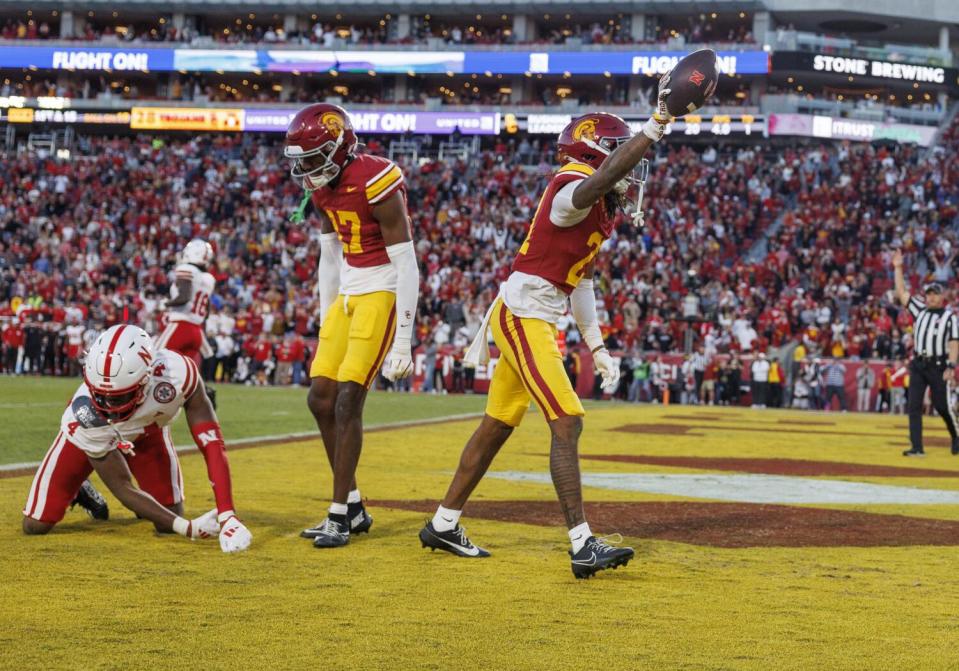 USC cornerback Greedy Vance, right, celebrates after intercepting a pass in the final seconds.