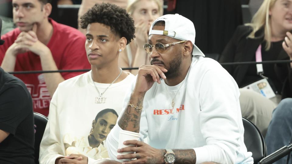 PARIS, FRANCE - AUGUST 8: Carmelo Anthony and his son Kiyan Anthony (left) attend the Men's Basketball semifinal game between Team France and Team Germany on day thirteen of the Olympic Games Paris 2024 at Bercy Arena on August 8, 2024 in Paris, France. (Photo by Jean Catuffe/Getty Images)