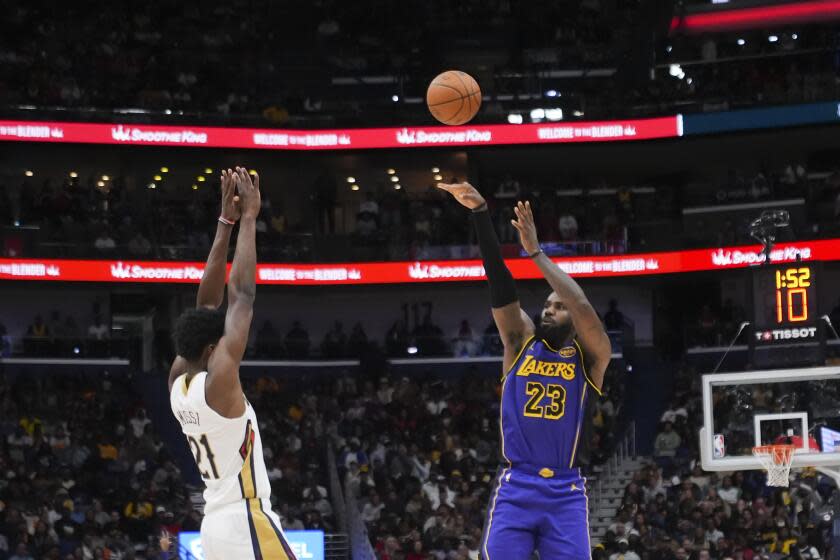 Los Angeles Lakers forward LeBron James (23) shots a 3-point basket against New Orleans Pelicans center Yves Missi (21) in the second half of an NBA basketball game in New Orleans, Saturday, Nov. 16, 2024. The Lakers won 104-99. (AP Photo/Gerald Herbert)