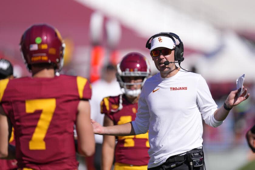 Southern California head coach Lincoln Riley, right, talks with quarterback Miller Moss.