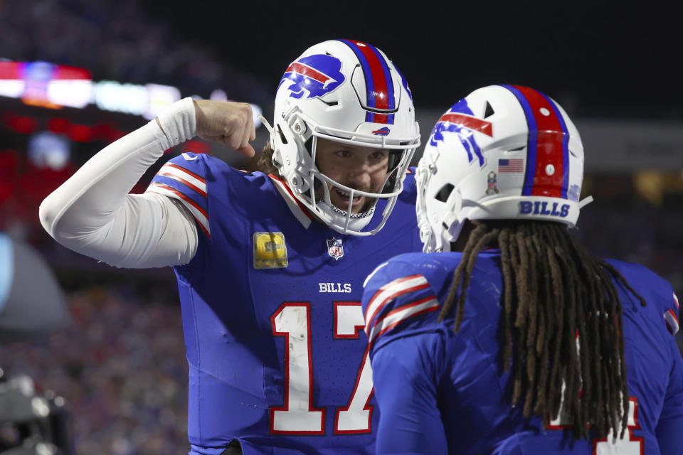 Buffalo Bills quarterback Josh Allen (17) is congratulates teammate James Cook, right, on his touchdown against the Chiefs. (AP Photo/Jeffrey T. Barnes)