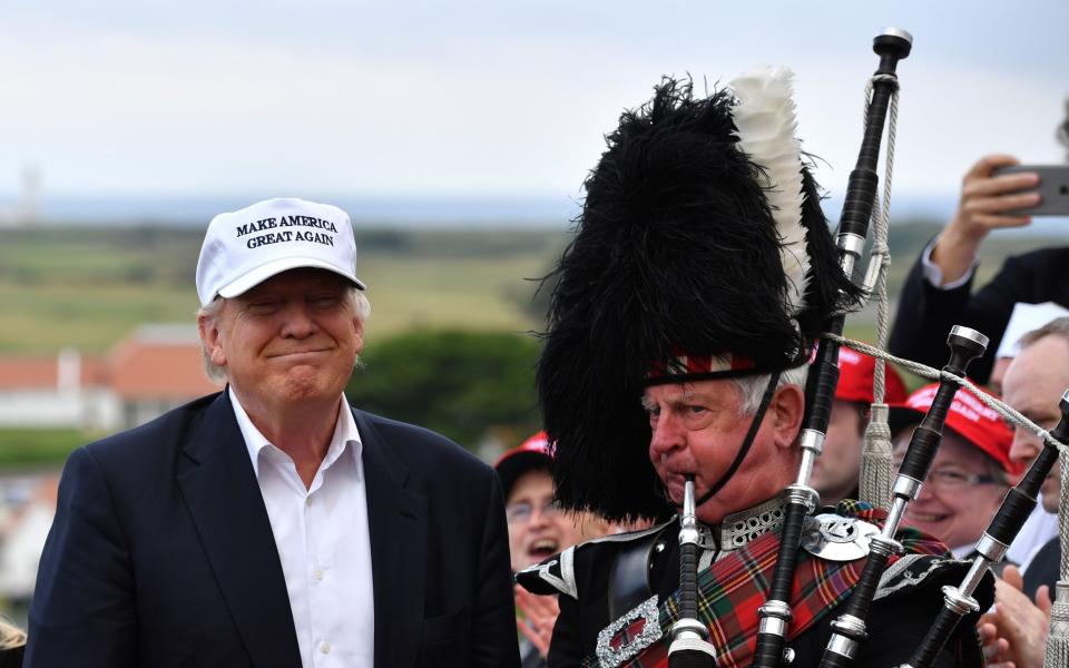 A bagpipe player next to Donald Trump as he arrives at Trump Turnberry Resort on June 24, 2016 in Ayr, Scotland