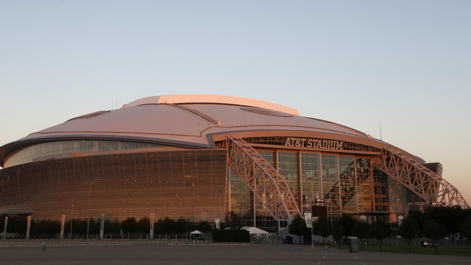 In this general, overall, exterior view of AT&T Stadium, the setting sun reflects its' sunlight on the home of the Dallas Cowboys, after an NFL football game against the Los Angeles Rams on Sunday, Oct. 1, 2017, in Arlington, Texas. (AP Photo/Michael Ainsworth)