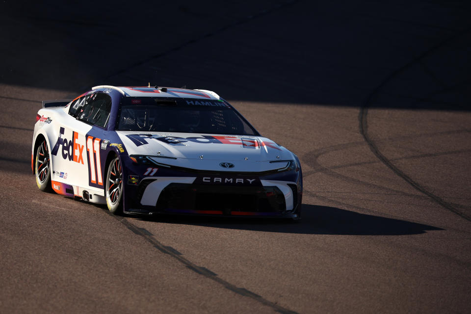 AVONDALE, ARIZONA - NOVEMBER 09: Denny Hamlin, driver of the #11 FedEx Toyota, drives during qualifying for the NASCAR Cup Series Championship Race at Phoenix Raceway on November 09, 2024 in Avondale, Arizona. (Photo by James Gilbert/Getty Images)